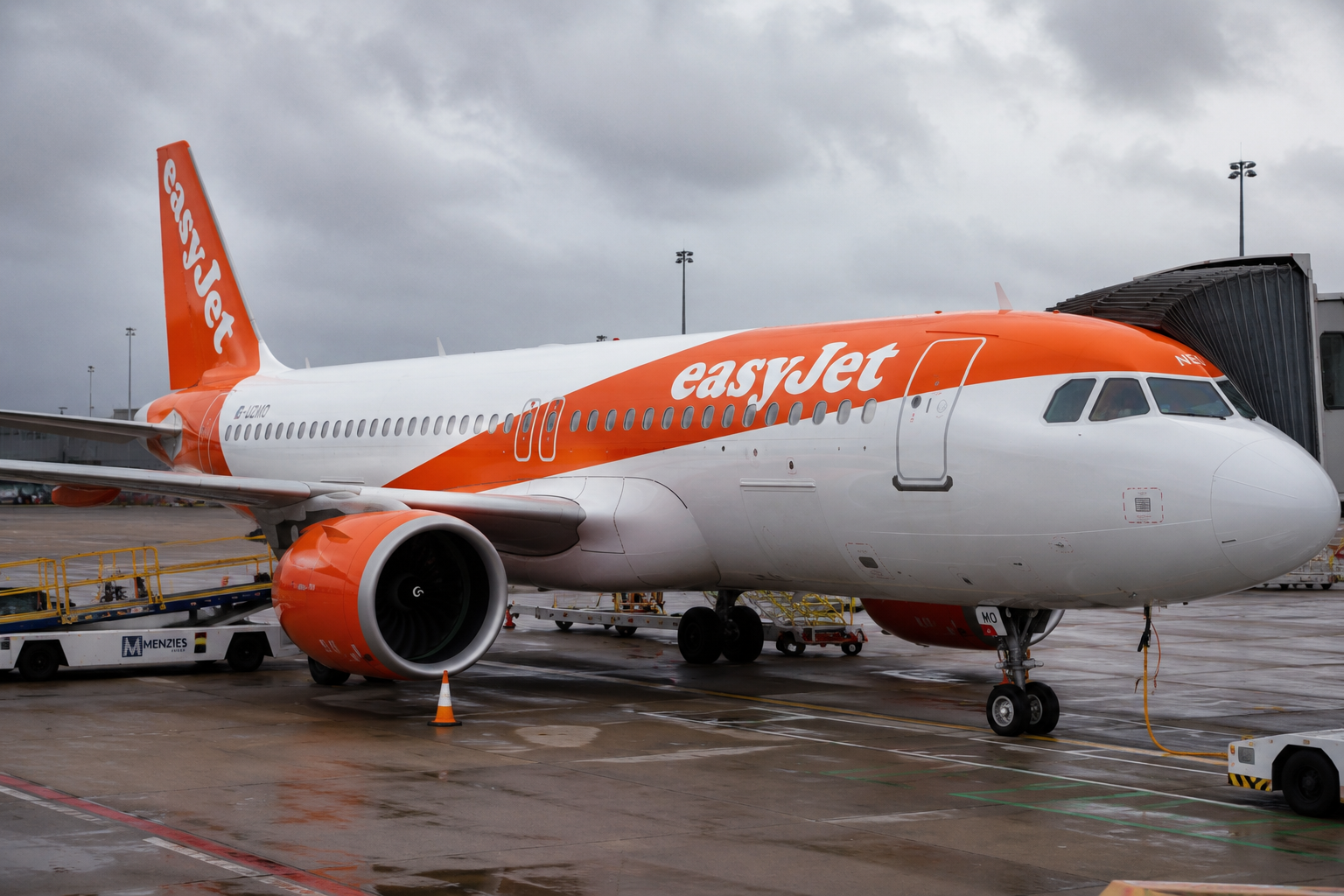 An easyJet airplane parked at an airport terminal following news of a proposed takeover agreement.