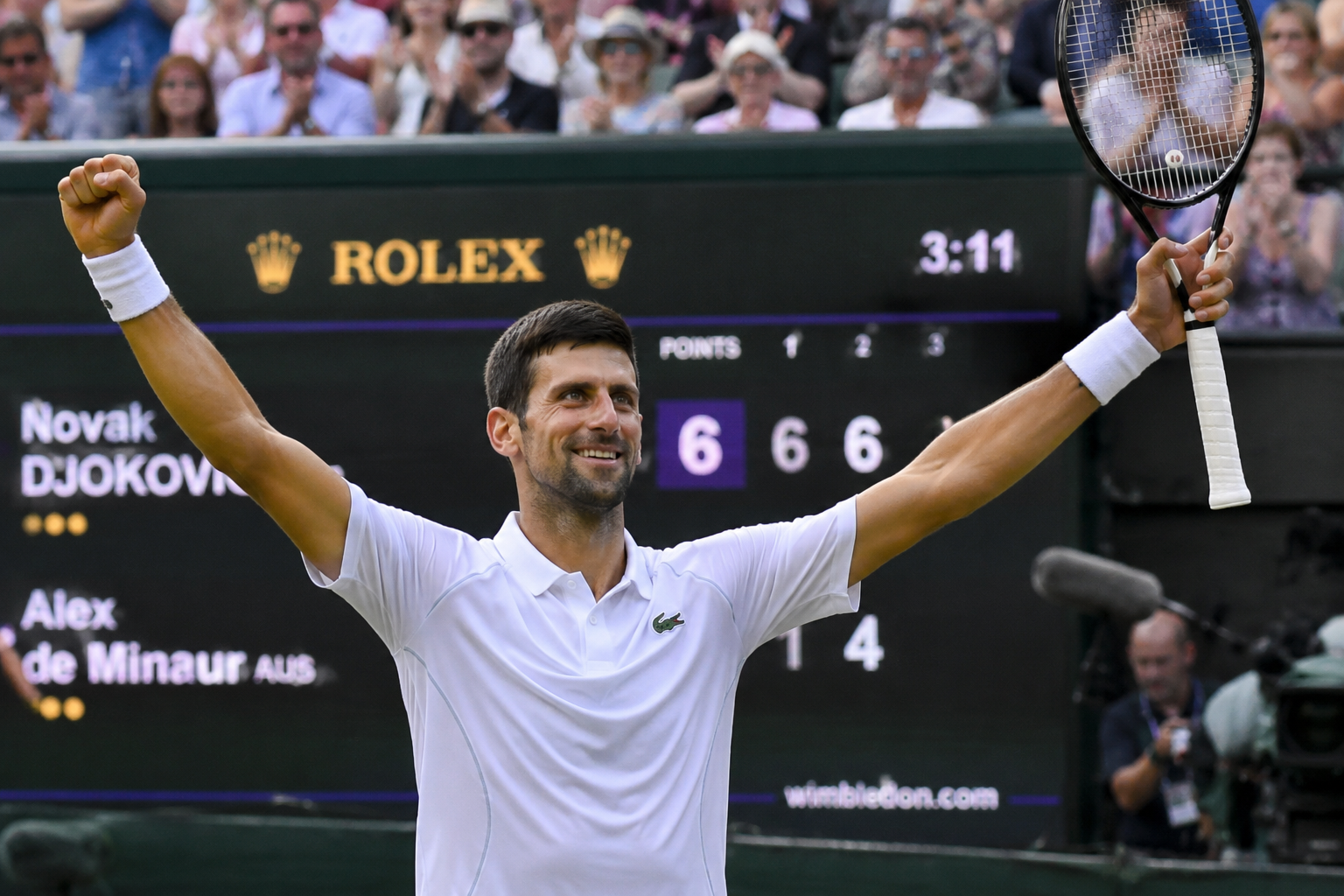 Novak Djokovic celebrating on Centre Court after advancing to the Wimbledon quarterfinals and setting a new tournament record.